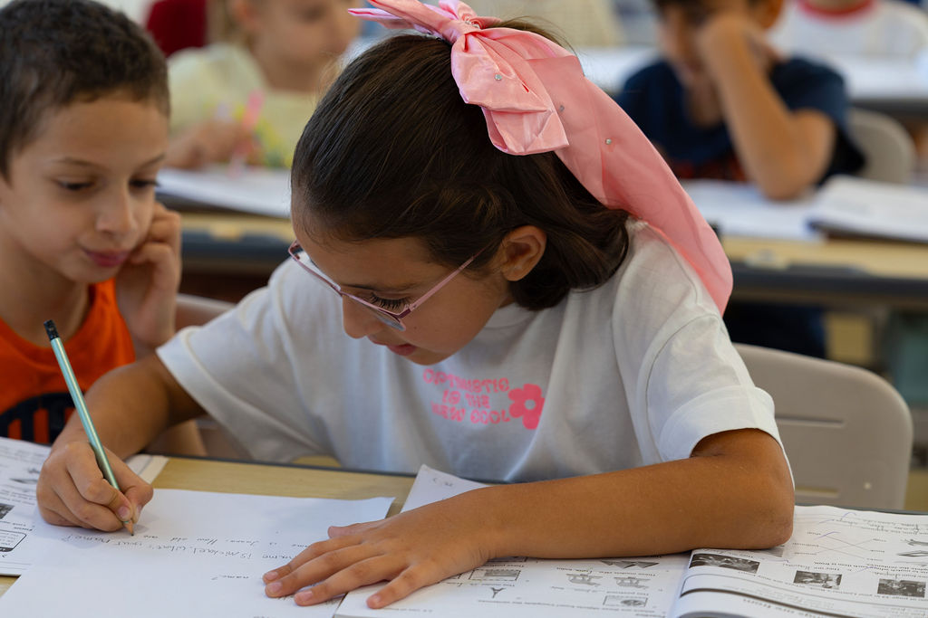 Pupils working with pencils and workbooks in a Golden Oak classroom.