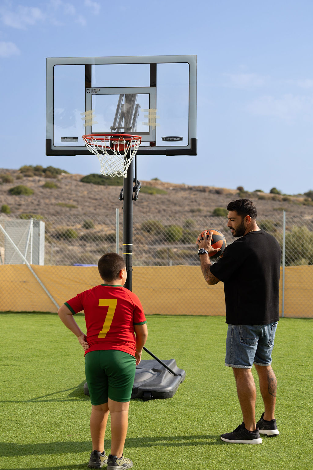 Teacher supporting a student during outdoor sports at Golden Oak Private School in Limassol