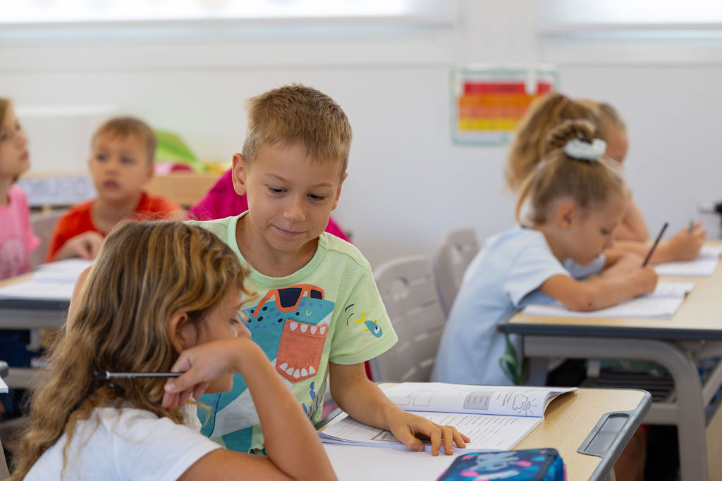 Pupils working together at classroom desks at Golden Oak.