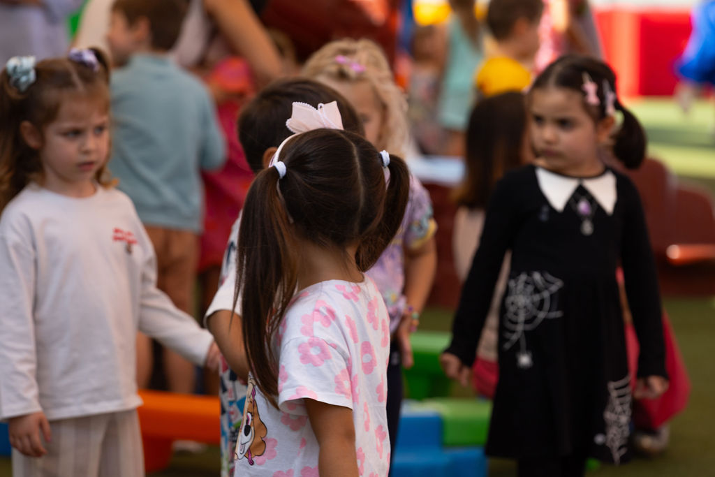 Children standing together in Golden Oak’s indoor preschool play area.