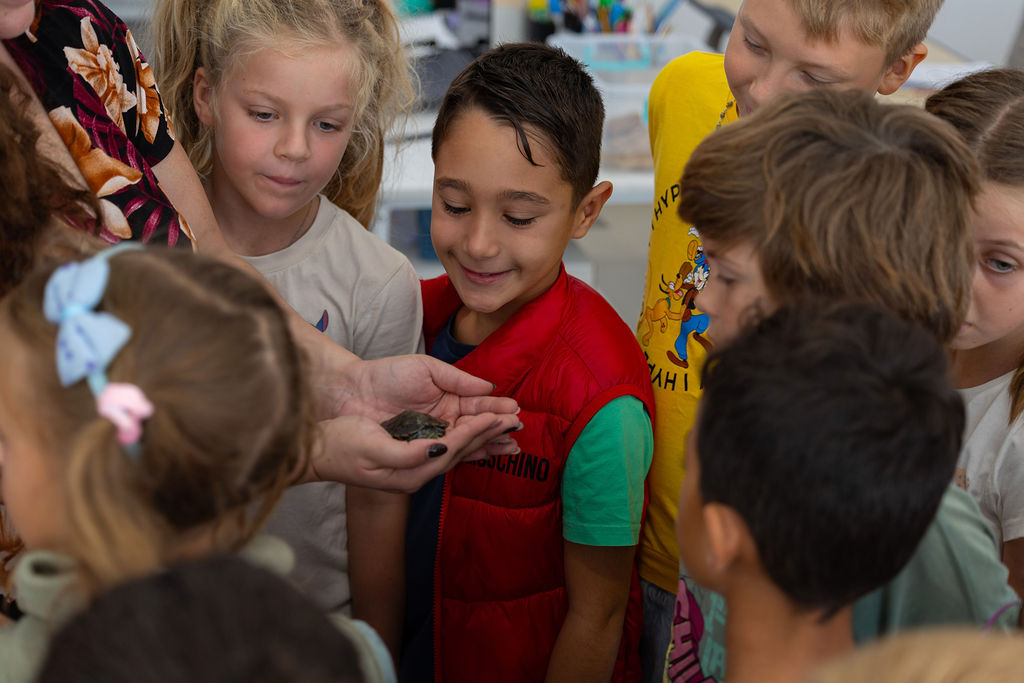 Golden Oak pupils gathered around an adult-led classroom activity.