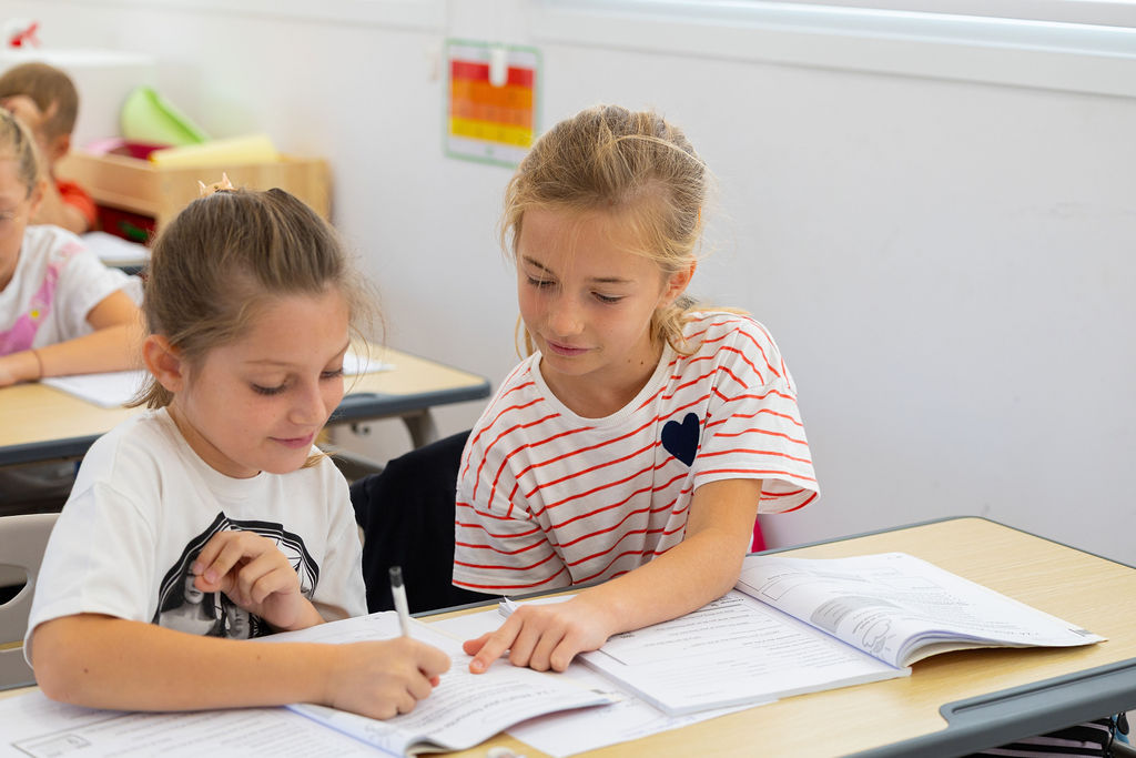 Two pupils reading and working together at Golden Oak.