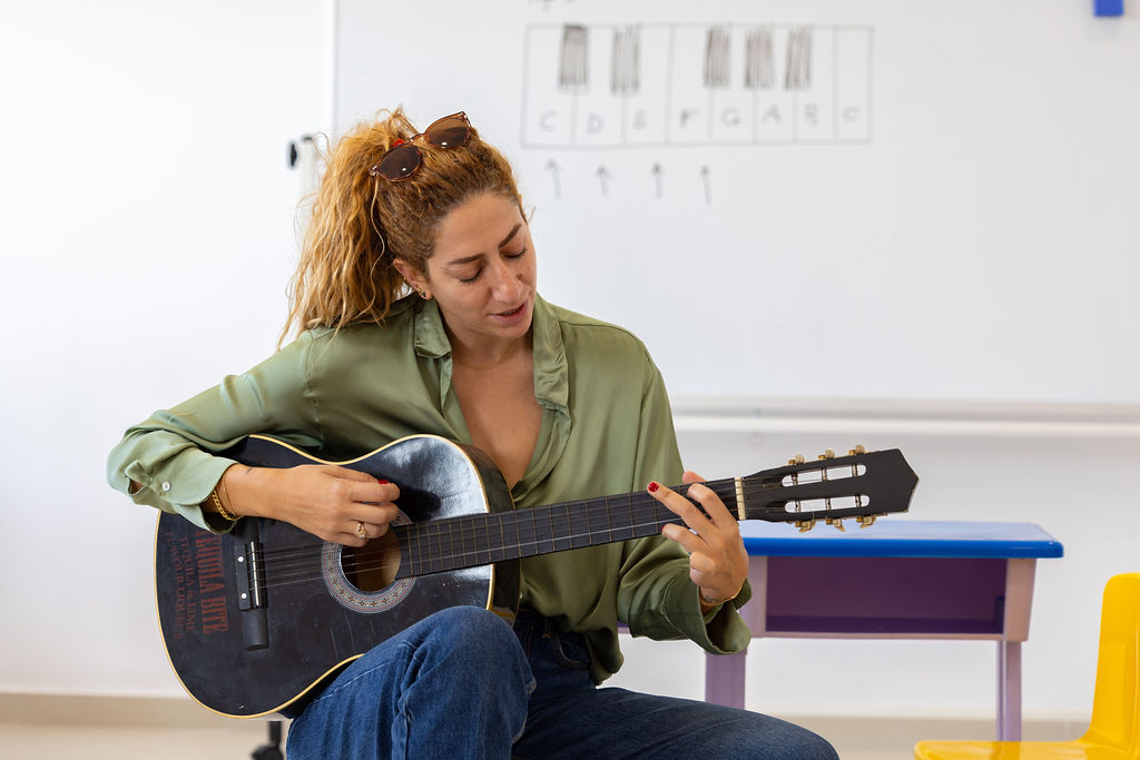 A Golden Oak teacher leading a music activity.